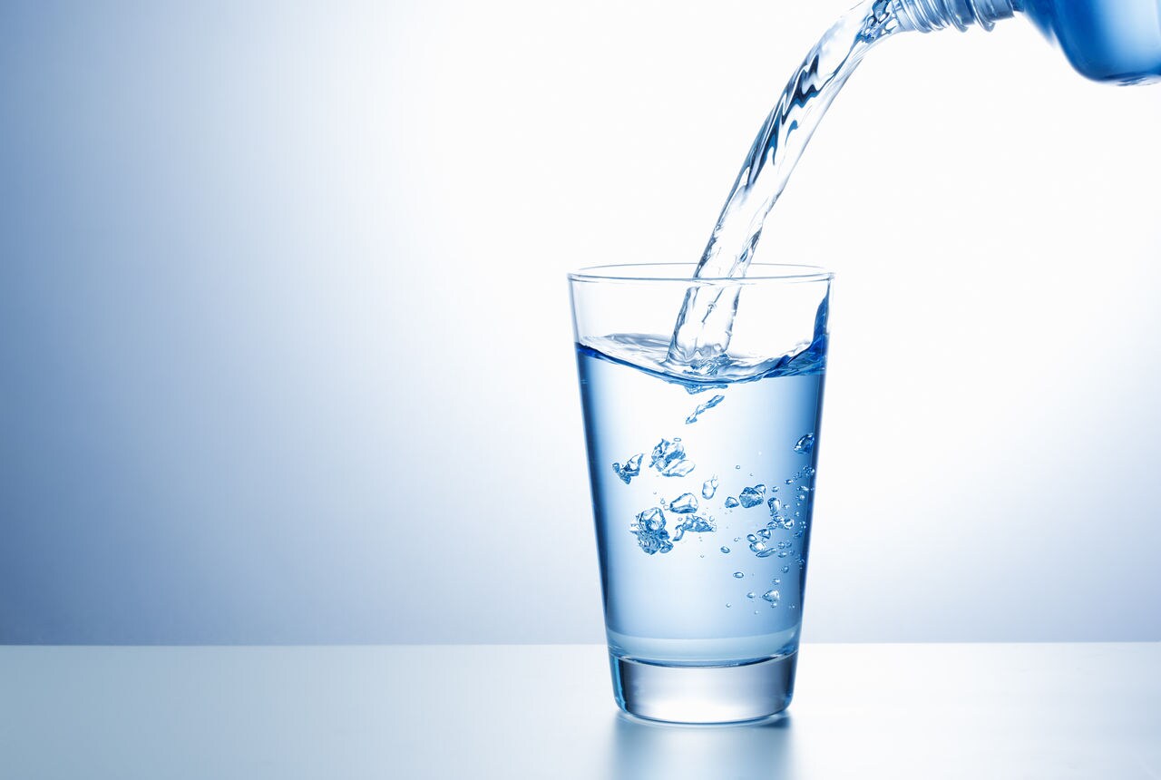 Pouring water from bottle into glass