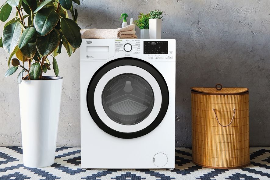 Interior of a real laundry room with a washing machine at home
