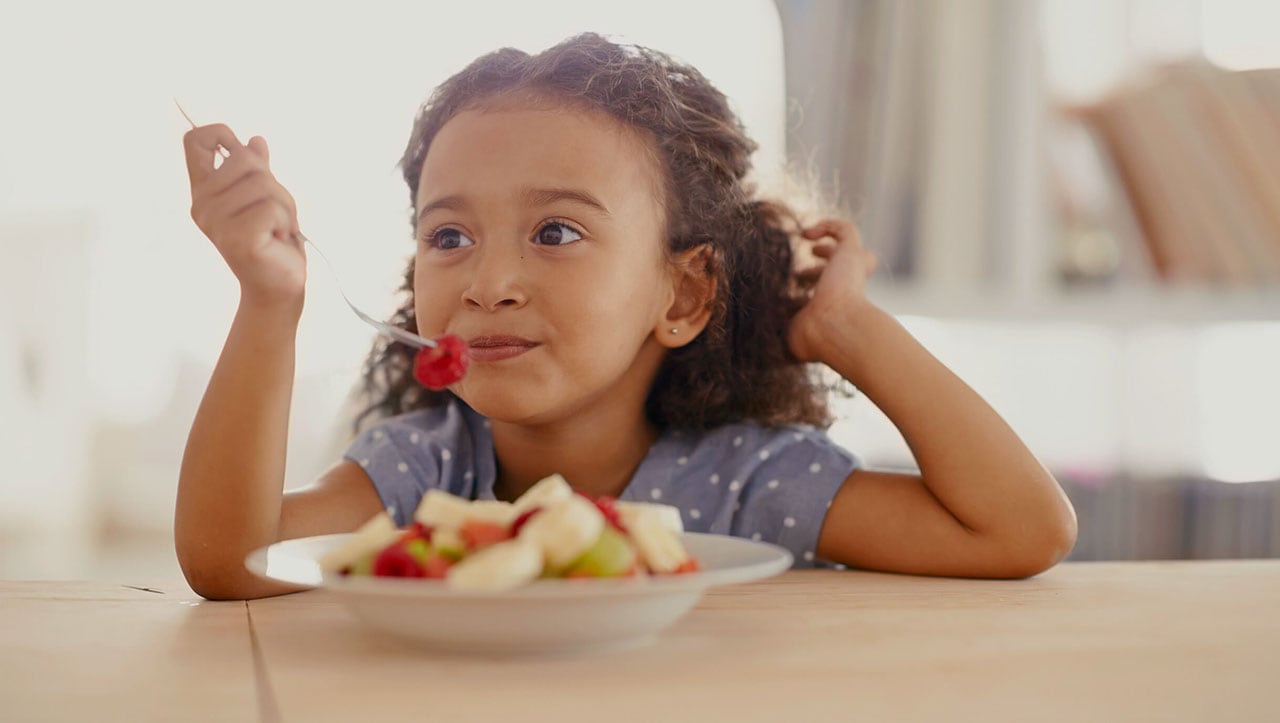 Girl eating healthy fruits