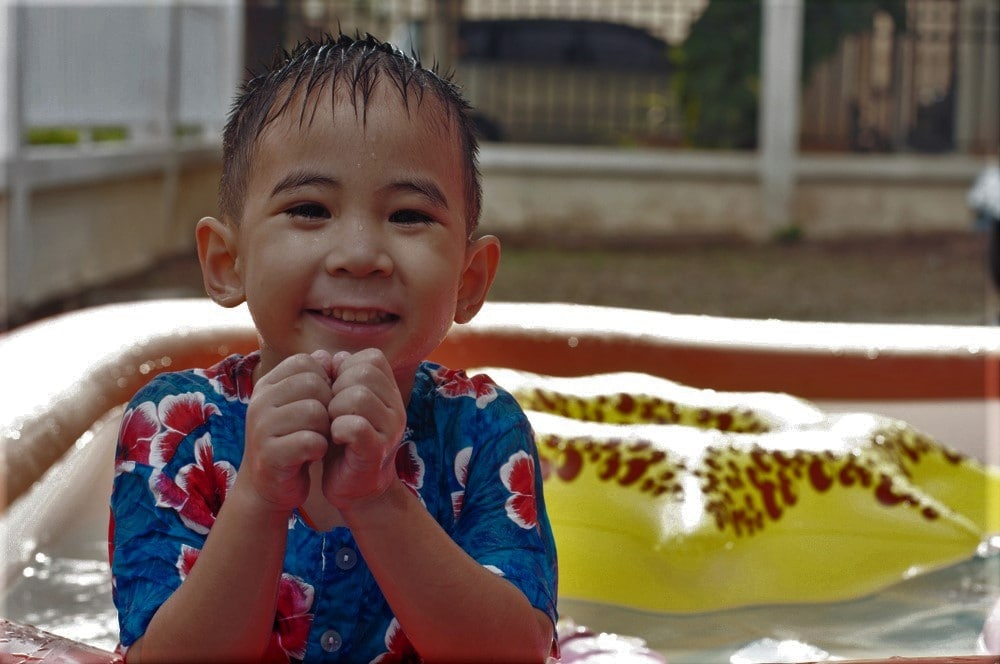 Cute Boy Smiling and Happy Playing Water