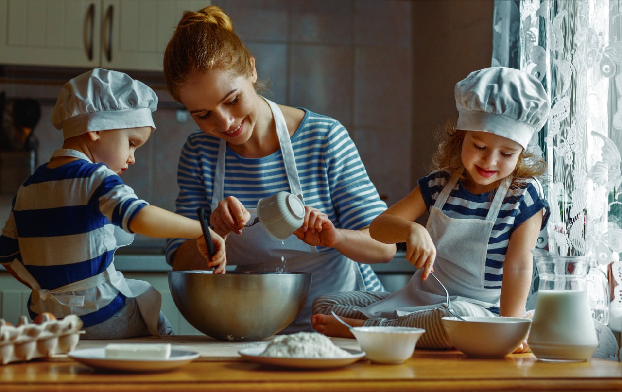 mom teaching kids to bake