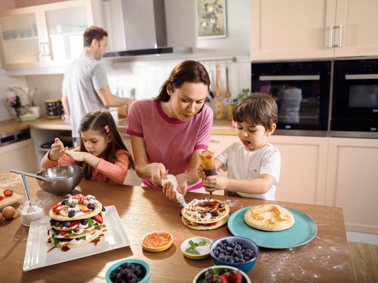 mother teaching kids to bake